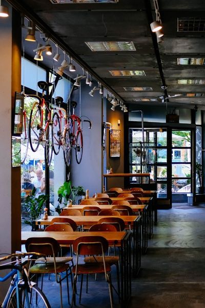 restuarant with many tables and bikes hanging as decoration