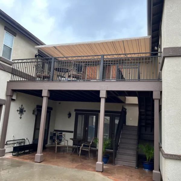 Retractable awning over balcony
