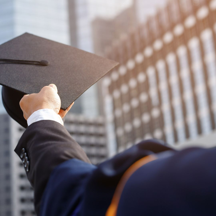 student holding graduation cap