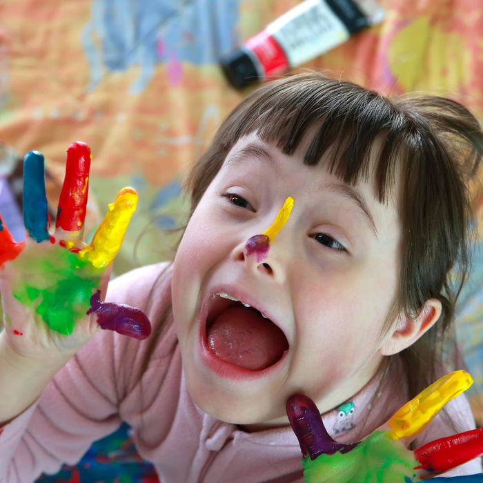 little girl playing with paint