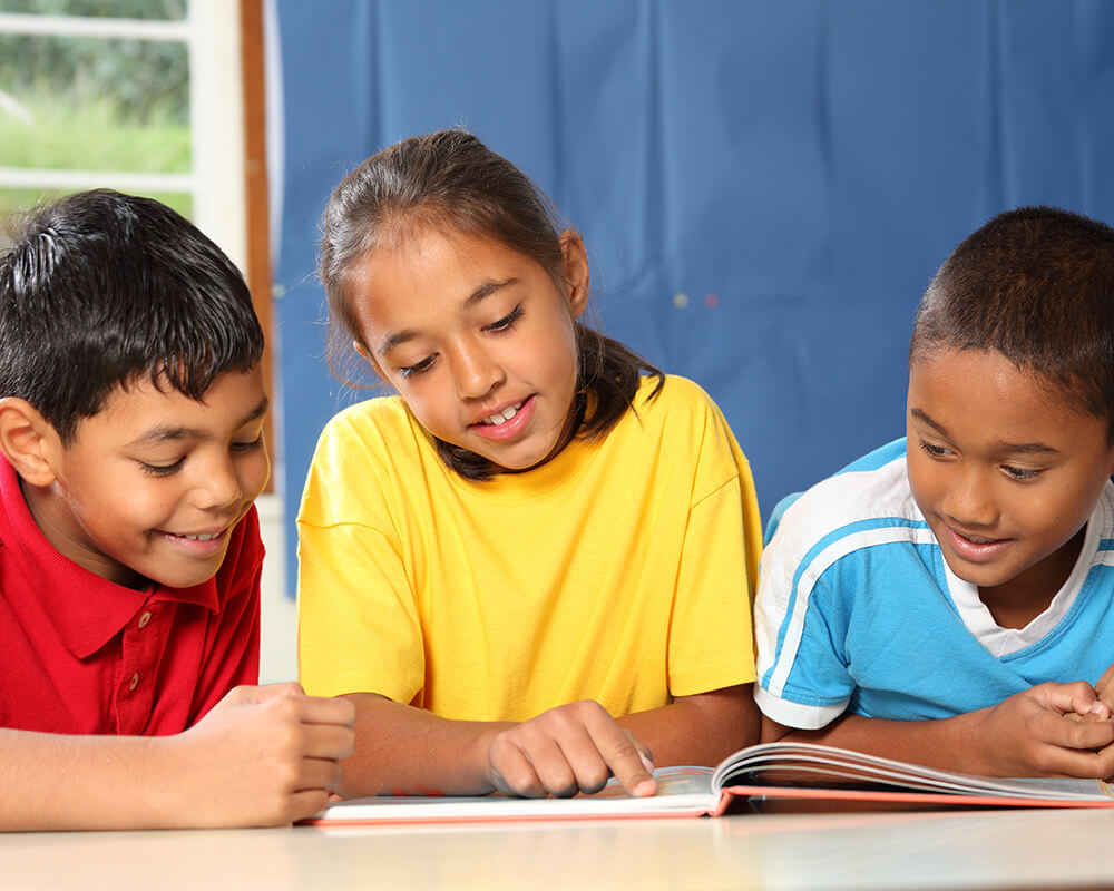 3 children reading a book 3 children reading a book