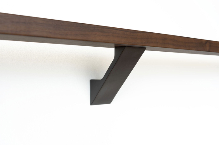 A sleek black modern wall-mounted handrail bracket from the Componance VS Series supporting a premium wood handrail against a clean wall. Componance VS Series Modern Wall-Mounted Handrail Bracket