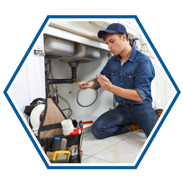 Plumber inspecting under sink
