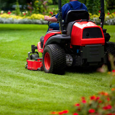 Someone using a riding lawn mower