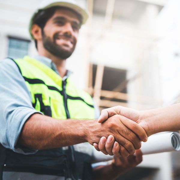 A contractor shaking hands with a client