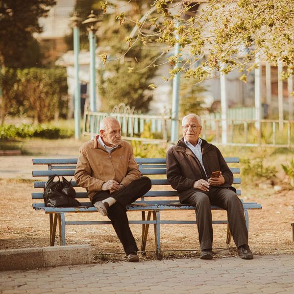 men on bench talking