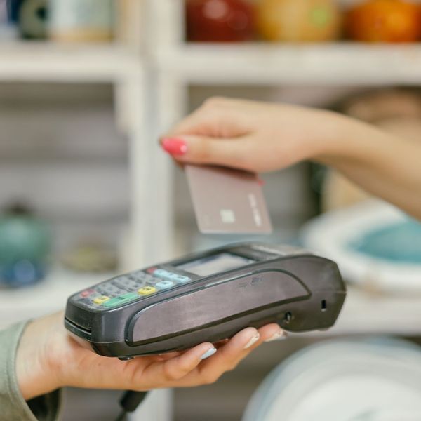 a person holding a POS machine Verifone Certification (4).jpg