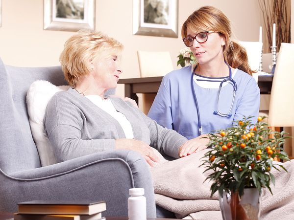 image of a nurse talking to an elderly patient