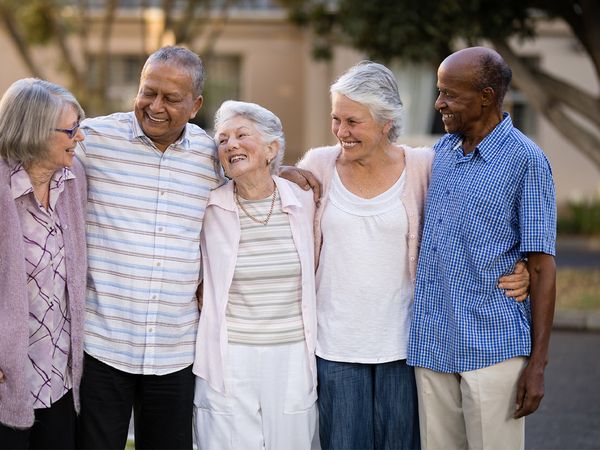 image of a group of senior citizens smiling together with their arms around each other