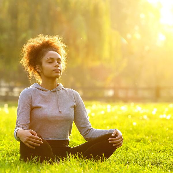 Woman meditating in grass