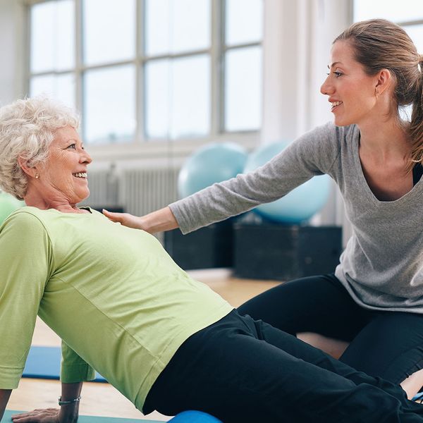 senior woman working with personal trainer