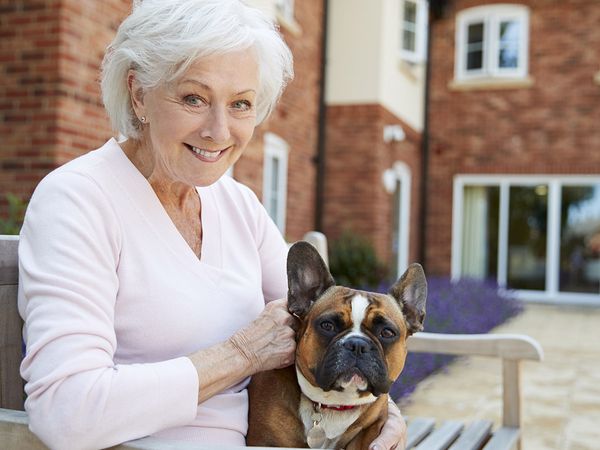 image of an elderly woman with her dog at an assisted living facility