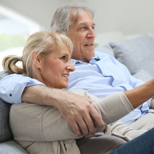senior couple watching tv