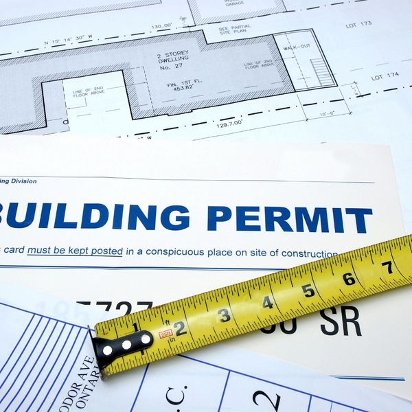 building permit and measuring tape