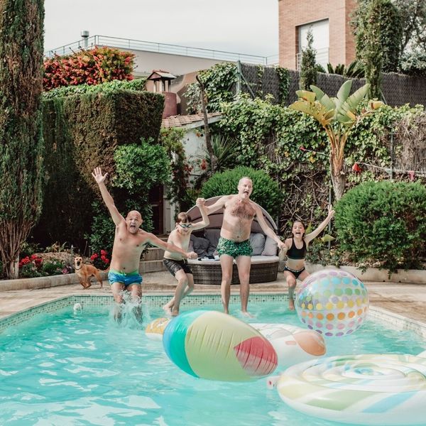 family jumping into pool
