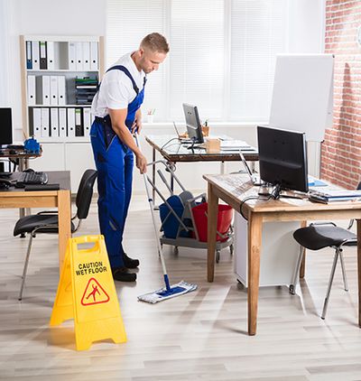 Image of a custodian cleaning an office