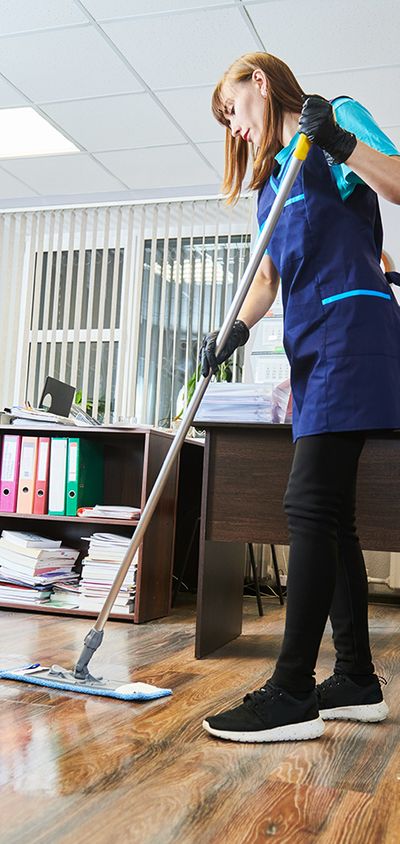A custodian mopping an office floor