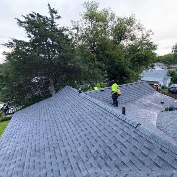 Image of a worker inspecting a roof.