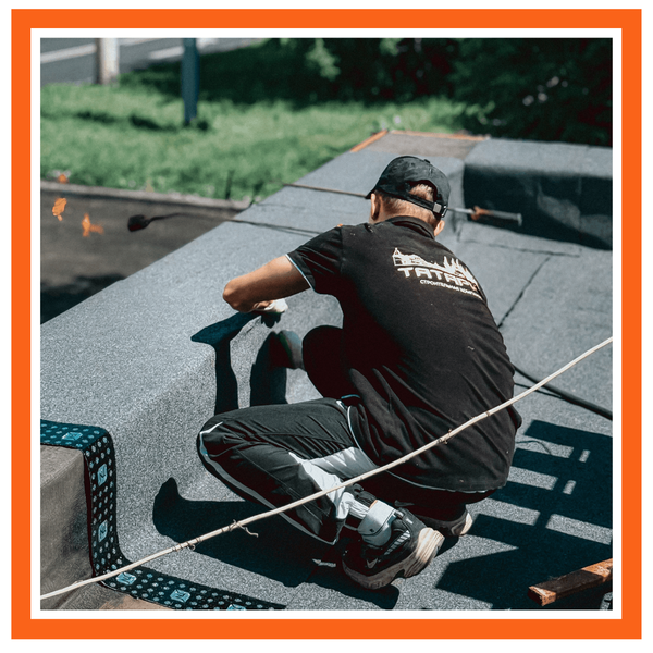 roofer installing a new commercial flat roof