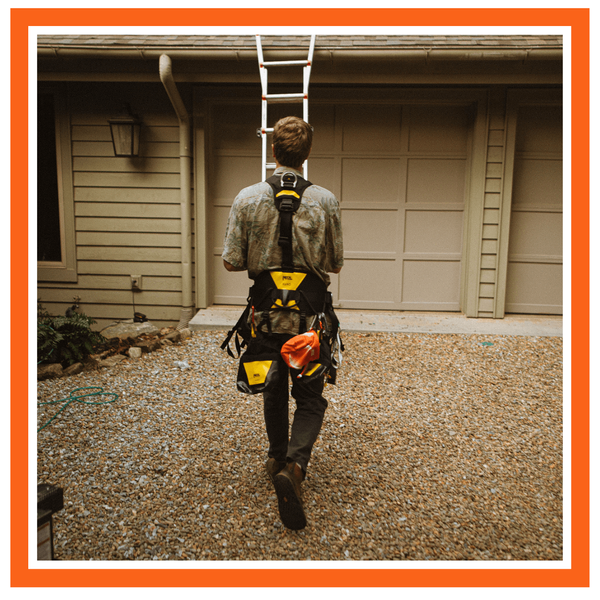 roofer getting ready to climb up to a roof