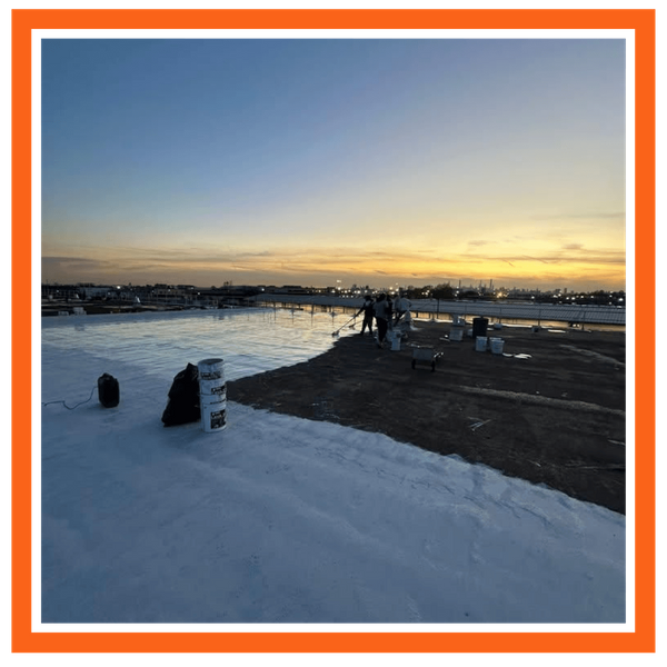 commercial roof coating being applied