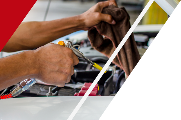 Hands cleaning a car engine