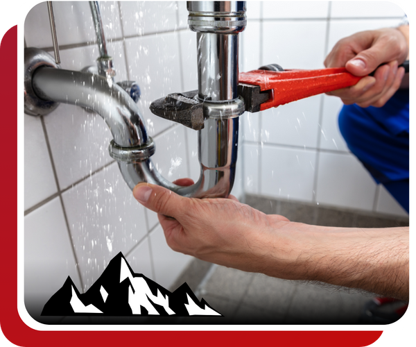 plumber fixing a leaky pipe