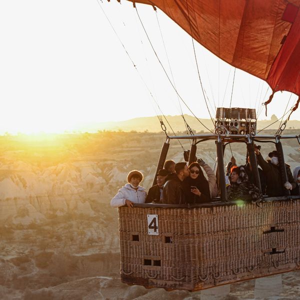 friends in basket of hot air balloon