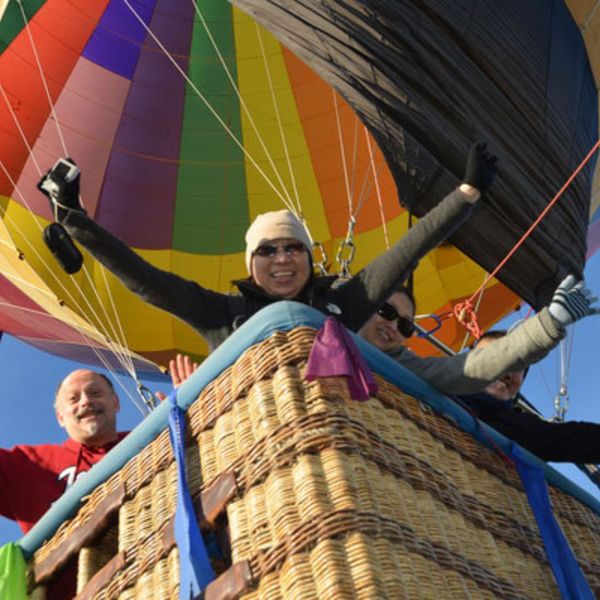 sunrise balloons riders in the basket