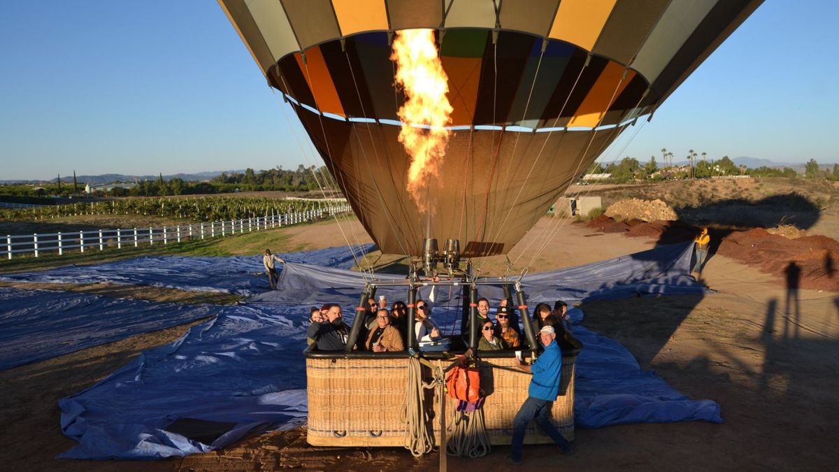 sunrise balloons riders on the ground