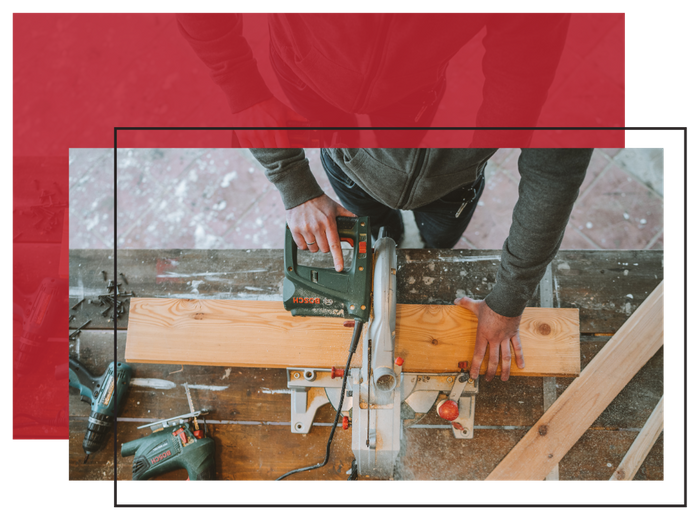 Man cutting wood with a saw Man cutting wood with a saw