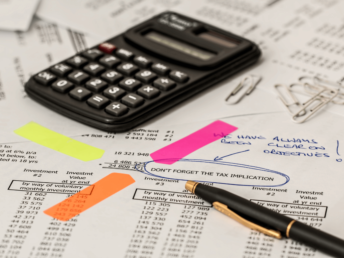 A picture of a calculator on top of financial documents.