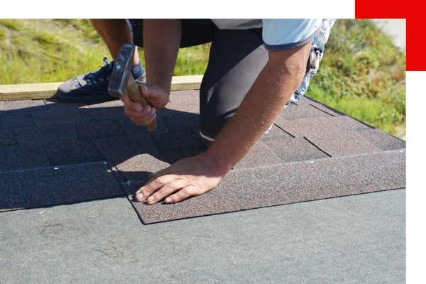 Roofer nailing shingles on roof