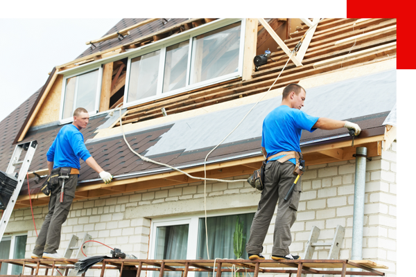 Two roofers working on new roof