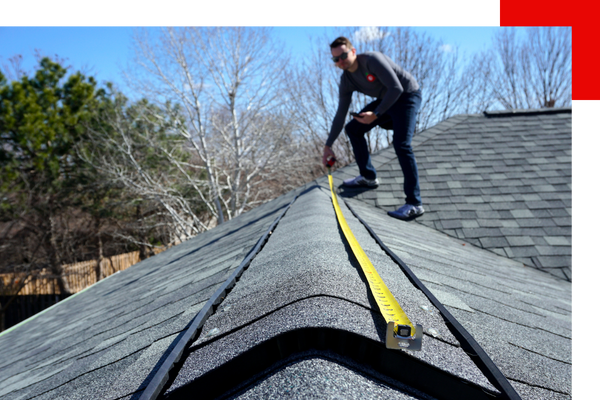 Contractor measuring roof