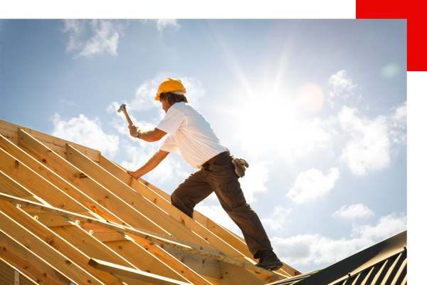 Residential roofer nailing roof structure together