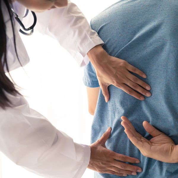 chiropractor touching person's back