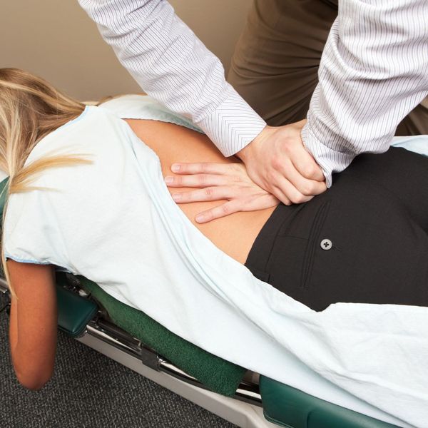 chiropractor adjusting person's back