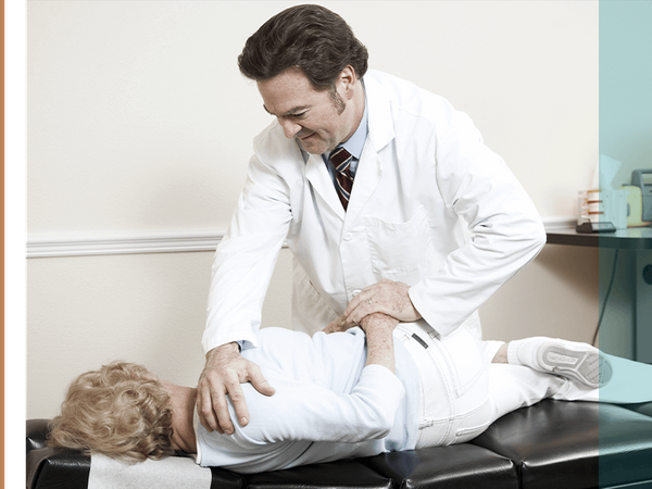 a chiropractor working on a patient