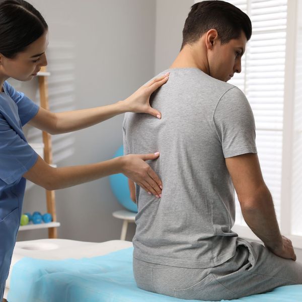 Chiropractor assessing someone's back