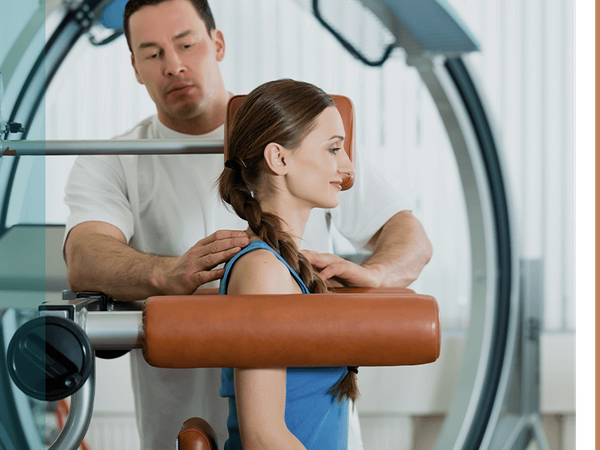 a client being adjusted in a machine by a chiropractor