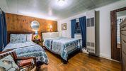 Cabin Bedroom at our historic cabins to rent in Asheville NC at the Log Cabin Motor Court
