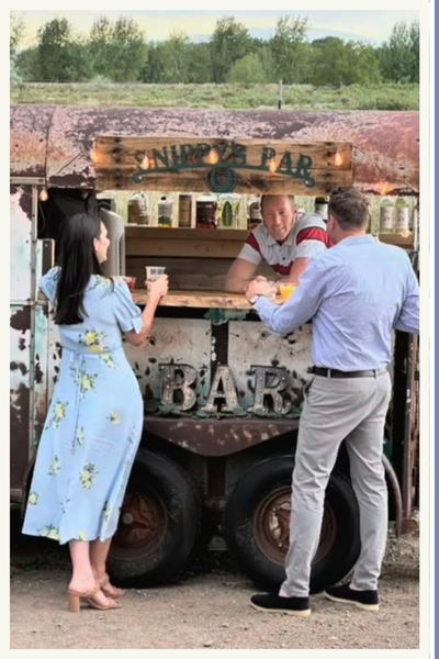 customers at mobile bar counter, friendly bartender leaning forward