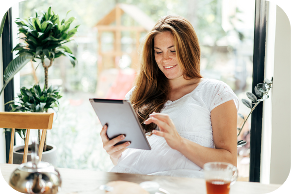 woman reading healthy lifestyle resources on tablet