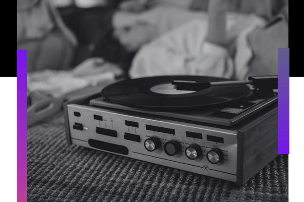 person laying listening to music from a record player About Us 1.png