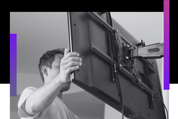 man mounts tv screen on wall TV installation 2.png