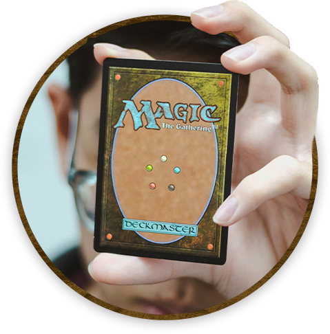 man holding up magic the gathering card