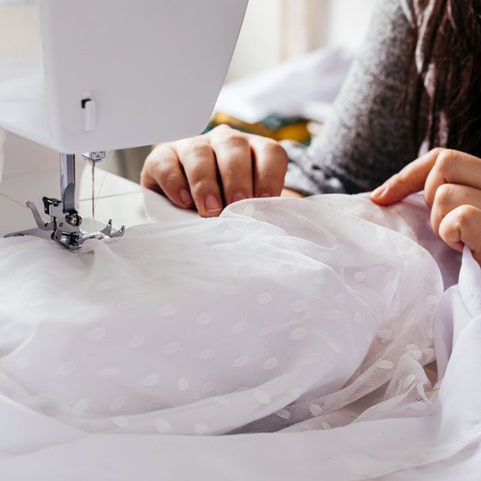 woman sewing a wedding dress