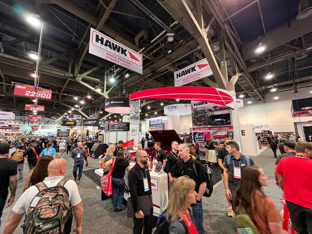 Busy trade show booth with lots of attendees at SEMA