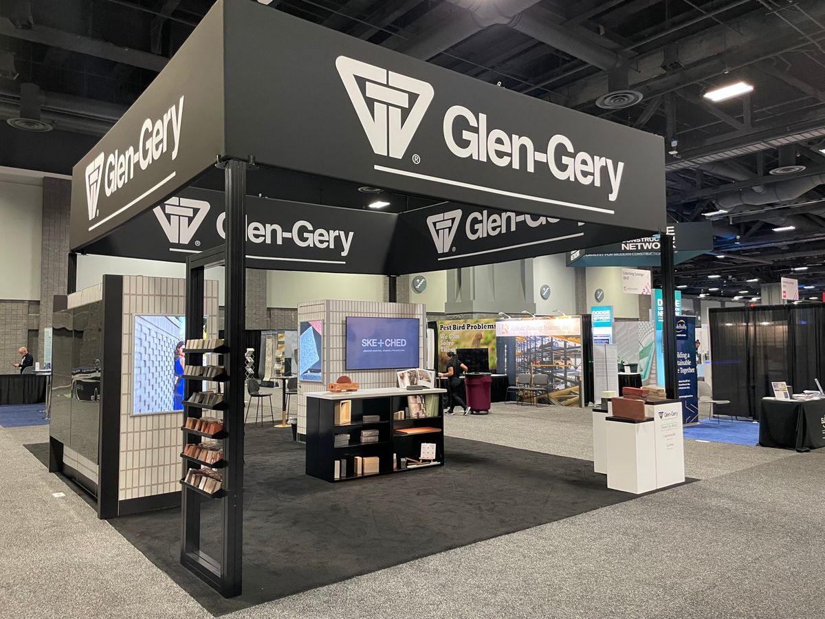 Product focused exhibit highlights key exhibitor product in many areas.  It also engages attendees with large overhead branding and a huge eye-catching video monitor wall